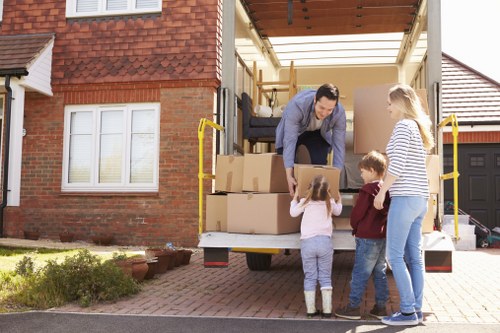 Removal van and mover near Richmond Upon Thames residential street