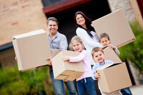 Packed moving boxes and furniture ready for transport in a local home